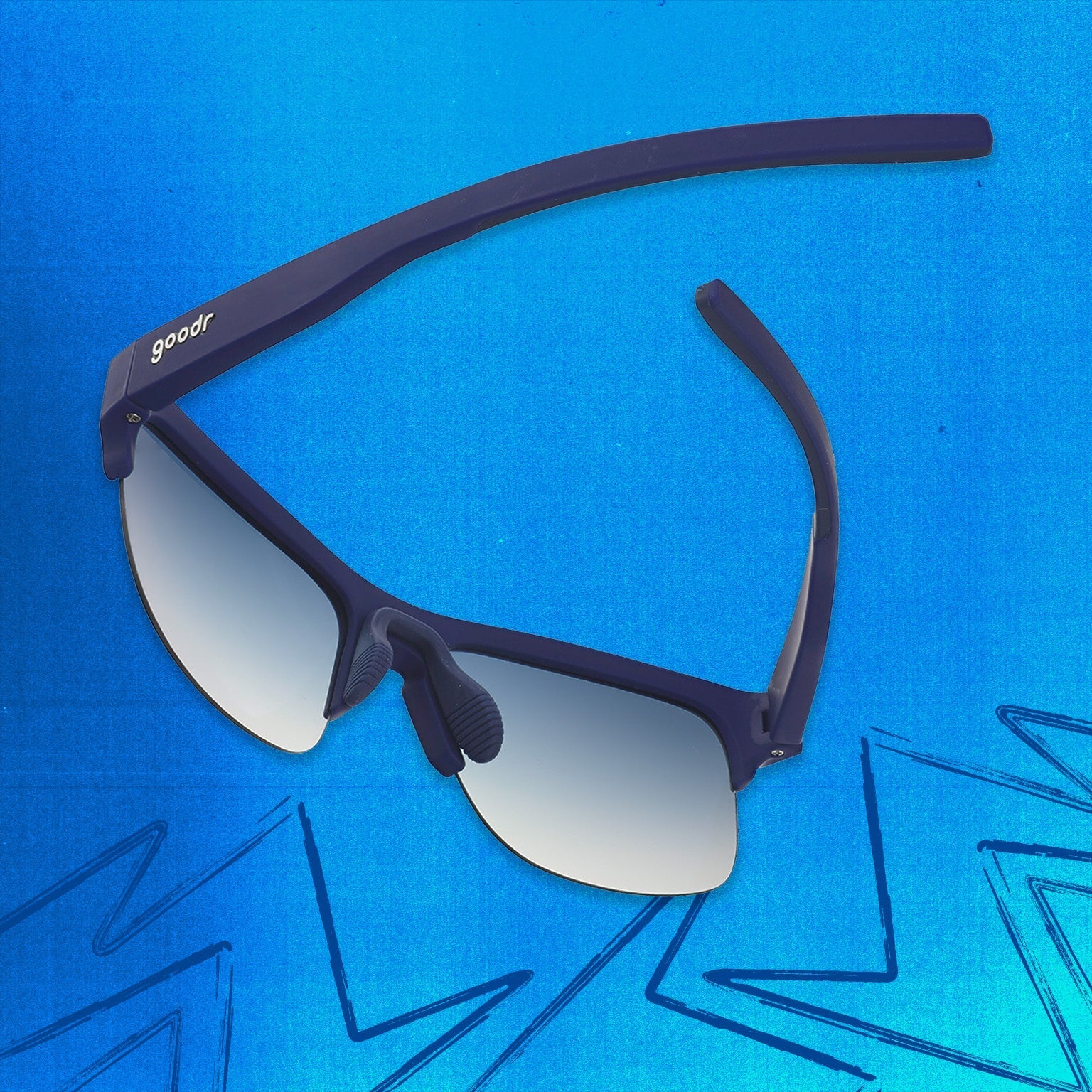 Three-quarter angle back view of navy blue shades with blue gradient lenses tilted down on a blue background.