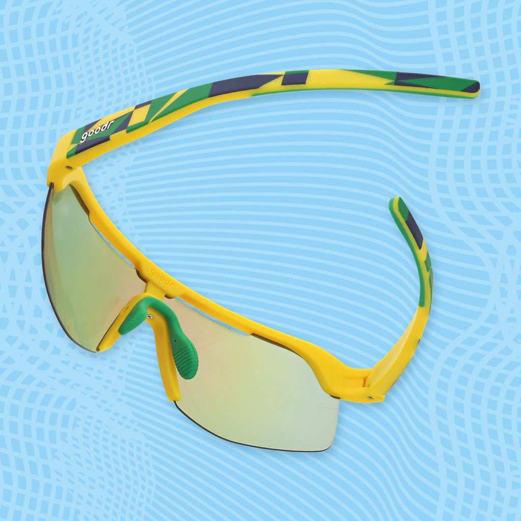 Angled view of yellow wraparound sunglasses with geometric green temple details and mirrored lenses.