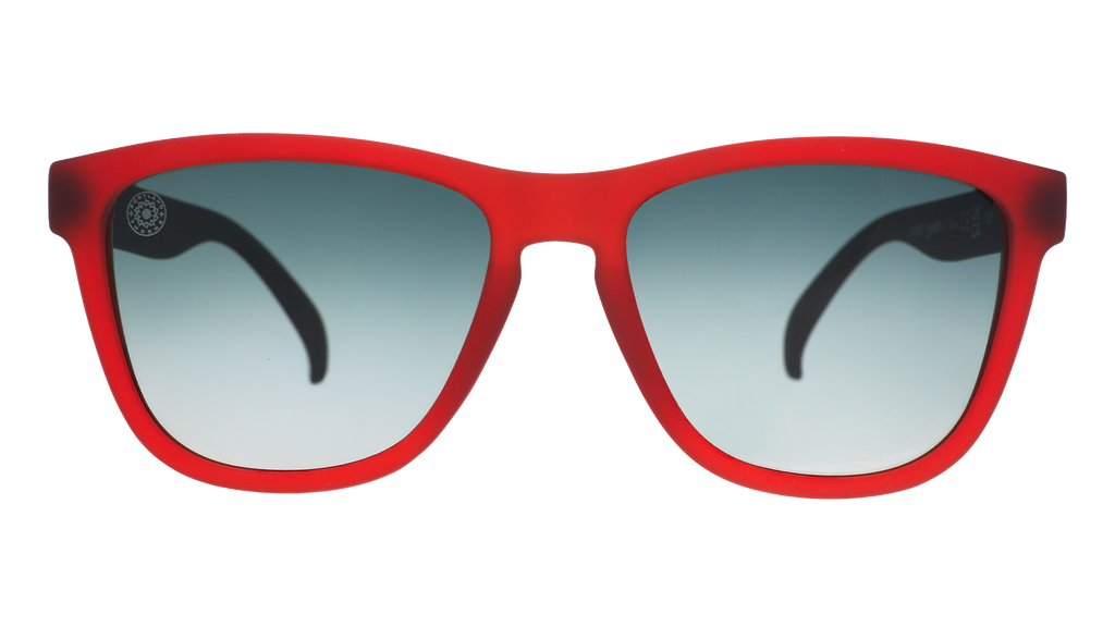 Front view of red and black sunglasses with green gradient lenses and the Portland Thorns logo etched into the lens.