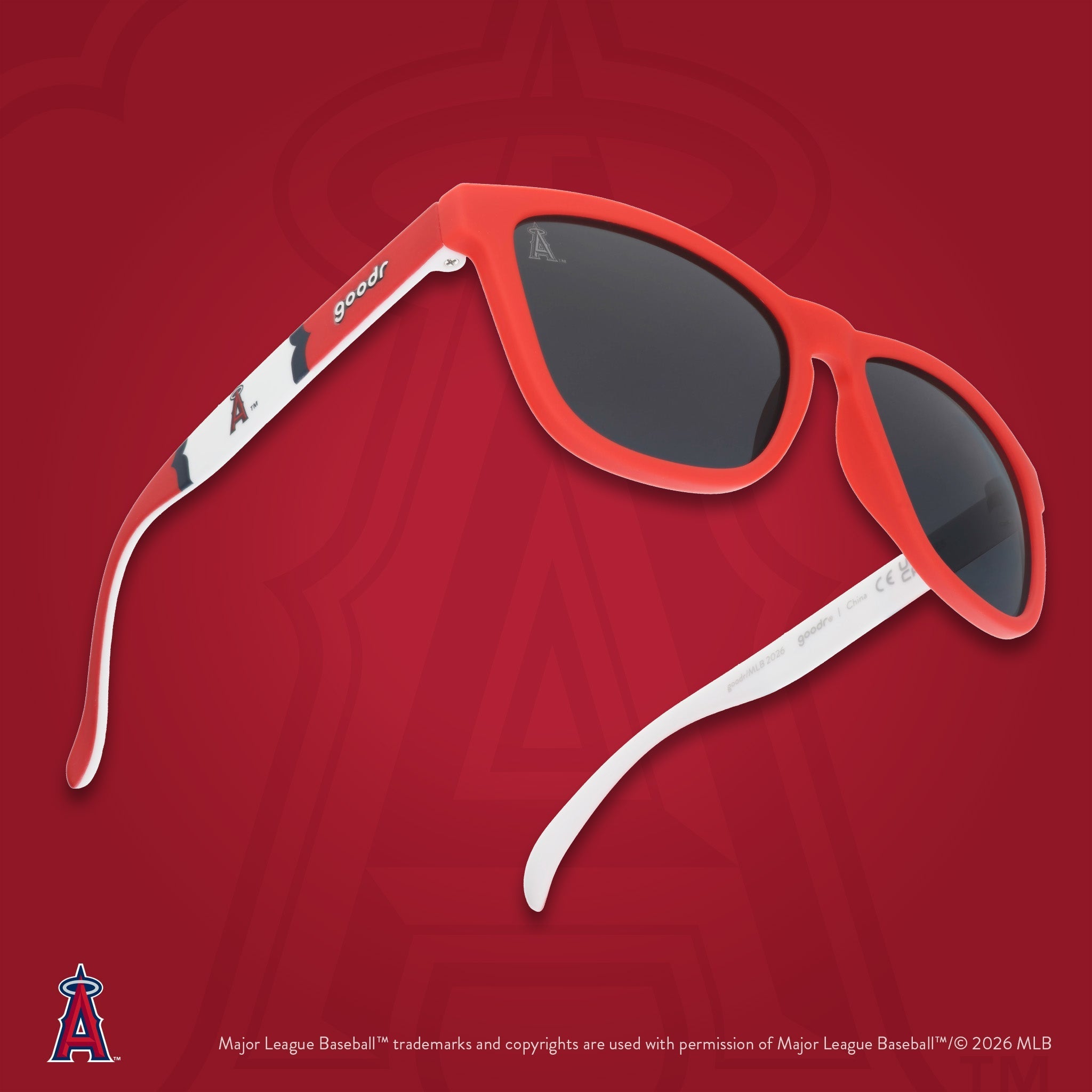 Three-quarter angle view of Angels sunglasses floating against a red background featuring the team's "halo A" logo.