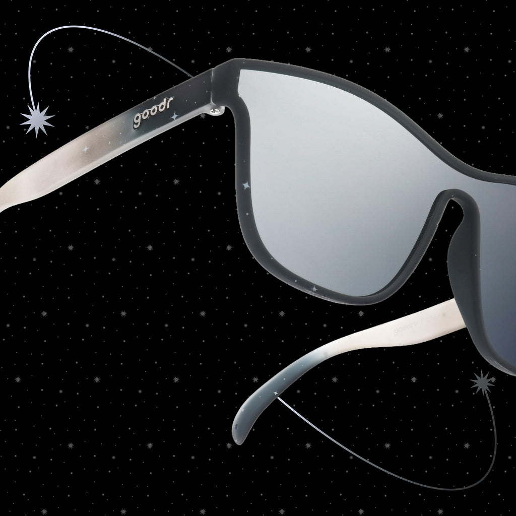 Close-up three-quarter view of translucent black and gray ombre VRGs featuring a cosmos design and a reflective chrome lens.