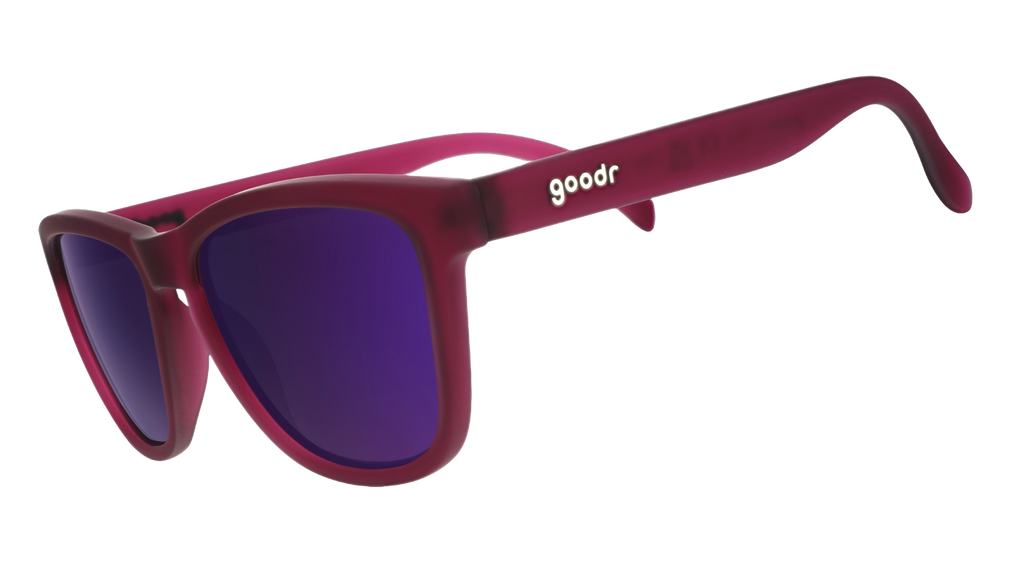 Three-quarter angle view of translucent purple sunglasses with reflective purple lenses.