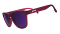 Three-quarter angle view of translucent purple sunglasses with reflective purple lenses.