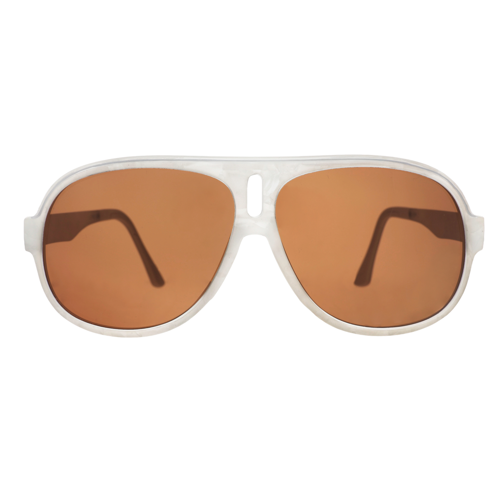 Aviator sunglasses with brown non-reflective lenses on a bright orange and pink starburst background.