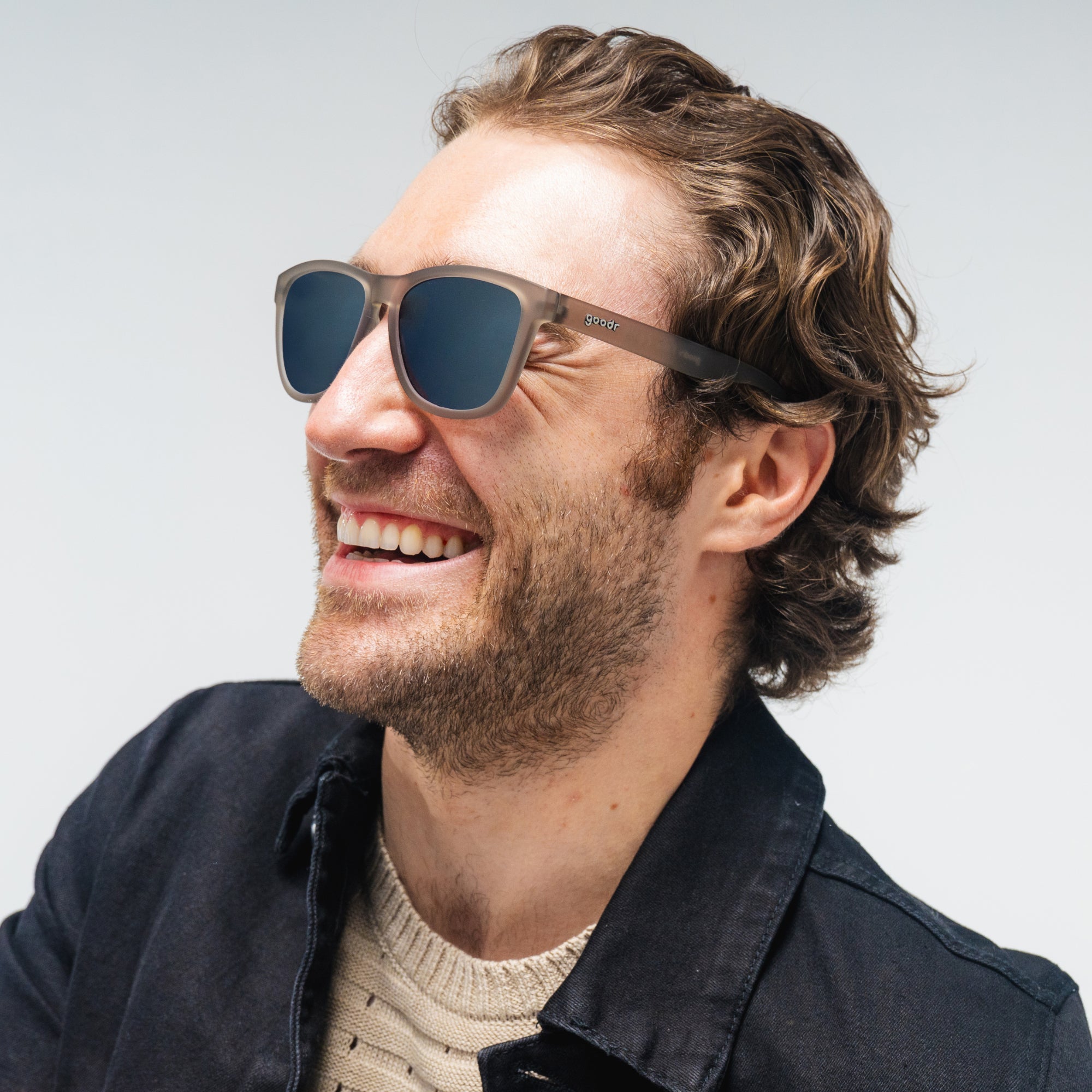 Man wearing sunglasses with a neutral background