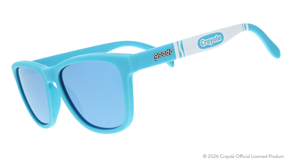 Three-quarter angle view of blue sunglasses w/ white Crayola marker pattern + blue reflective lenses tilted down.