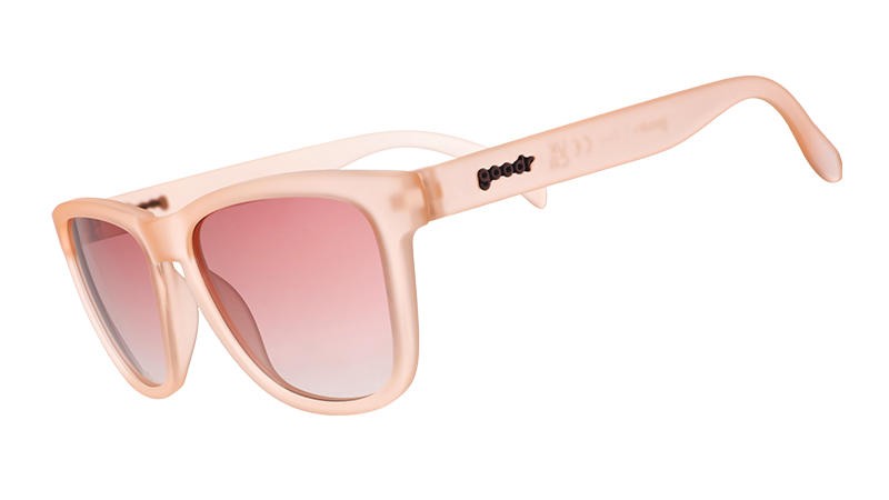 Sunglasses with translucent pink frames and gradient pink lenses.