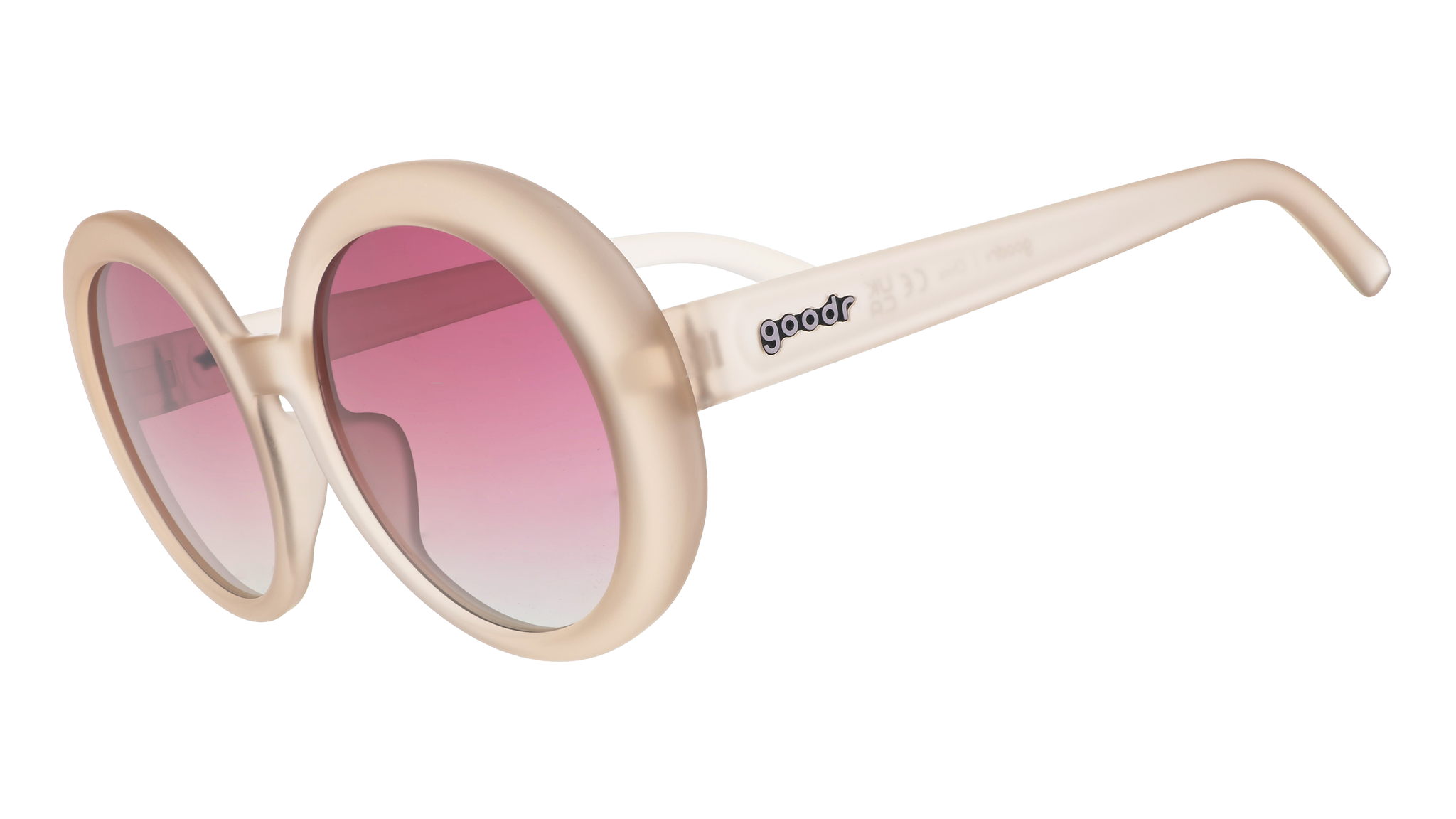 Three-quarter angle view of oversized round beige sunglasses with purple gradient lenses against a white background.