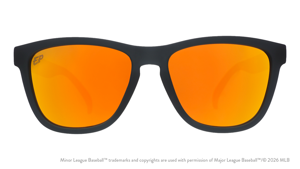Front view of sunglasses. Dark gray front frame. Amber reflective lenses. Chihuahuas logo etching in top corner of lens.