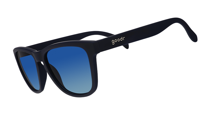 Sunglasses with a sleek navy frame and blue gradient lenses. The arms are solid black, featuring the goodr logo in white near the hinge.