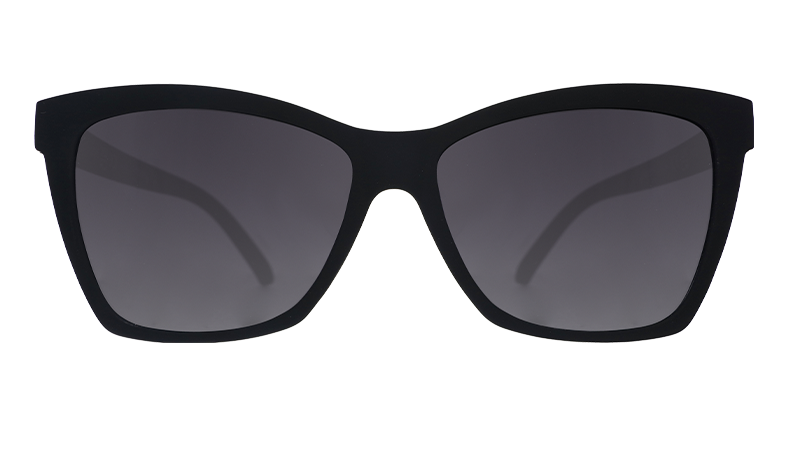 Front view of stylish black sunglasses with an angled cat-eye shape and non-reflective black gradient lenses.