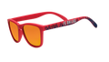 Three-quarter angle view of shades tilted down. Red frames w/blue flames+FC Dallas on temples. Amber reflective lenses.