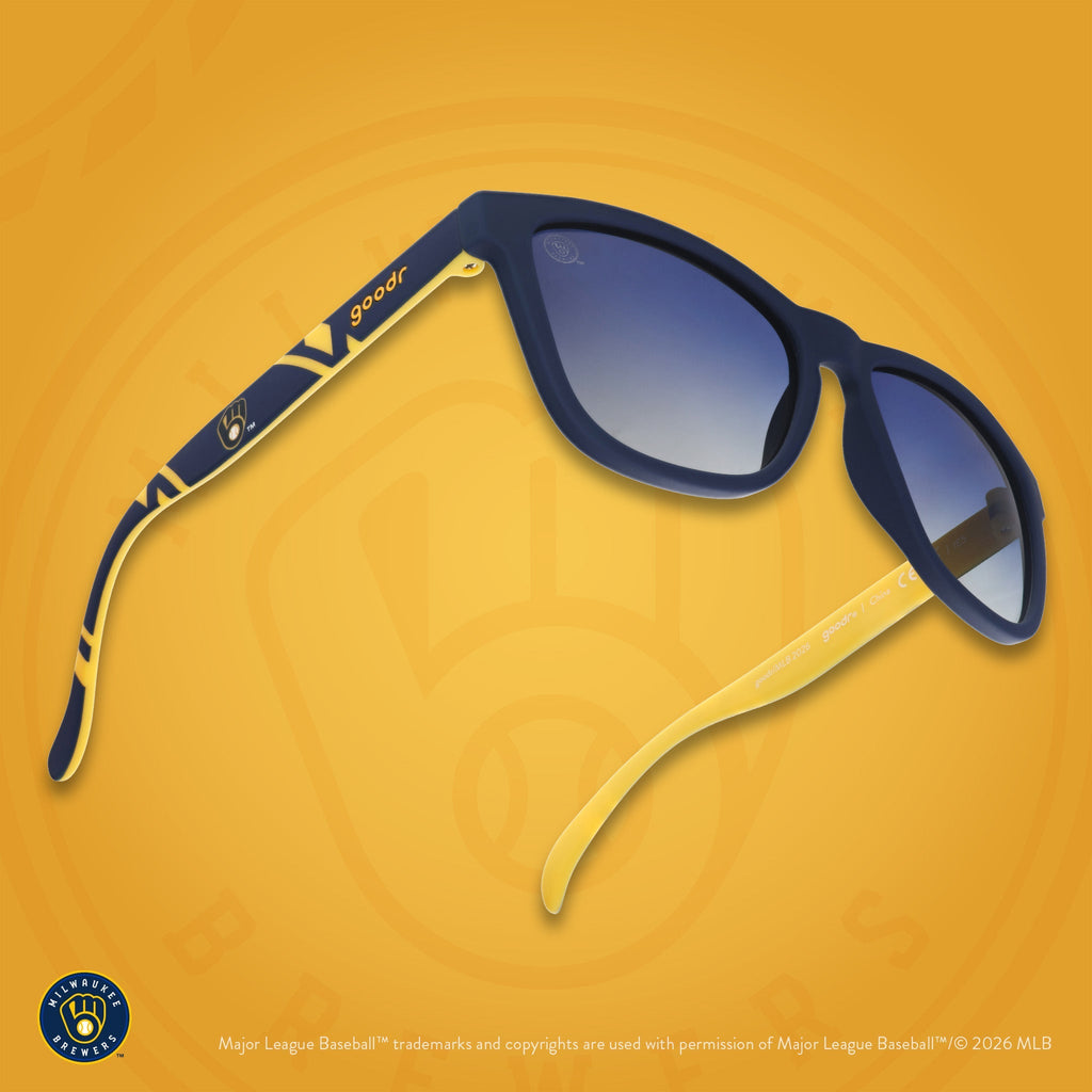 Three-quarter angle view of a pair of navy and yellow sunglasses featuring a Milwaukee Brewers logo on the arm.