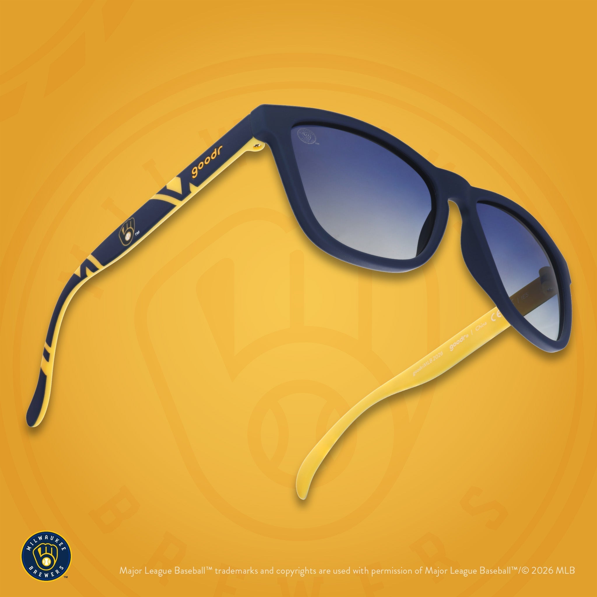Three-quarter angle view of a pair of navy and yellow sunglasses featuring a Milwaukee Brewers logo on the arm.