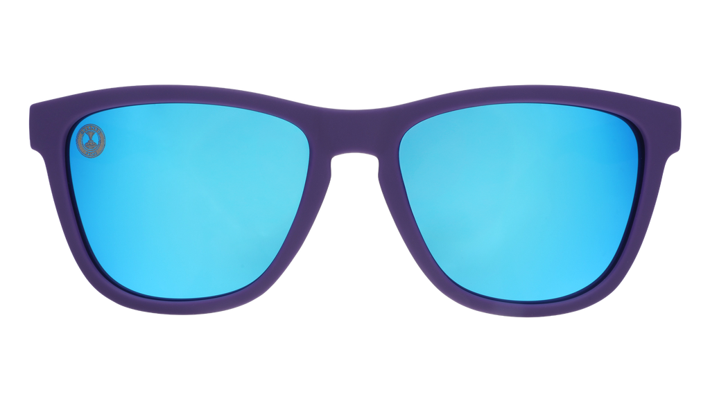 Sunglasses with blue lenses and purple frame on a white background