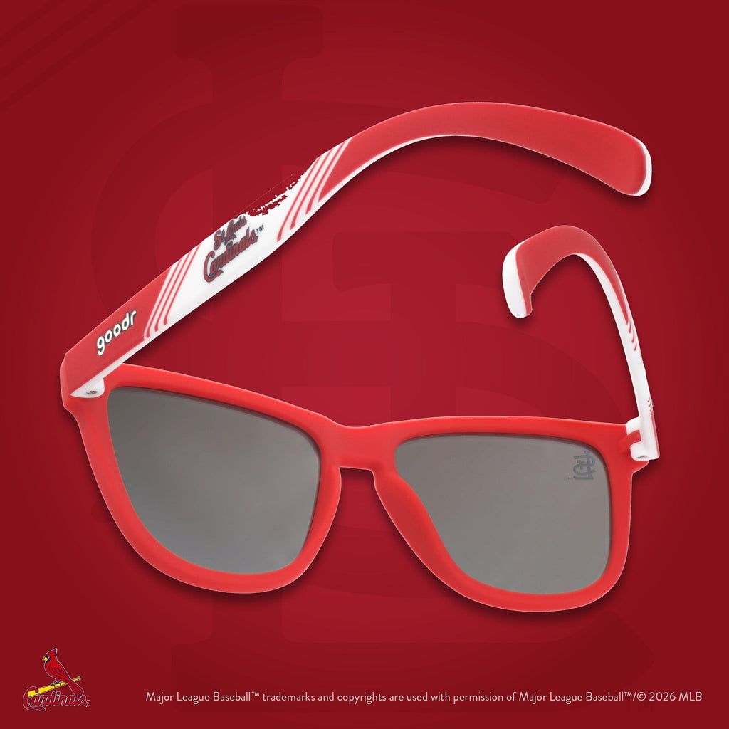 Red and white Cardinals shades photographed from behind, floating against a red background featuring the St. Louis StL logo.
