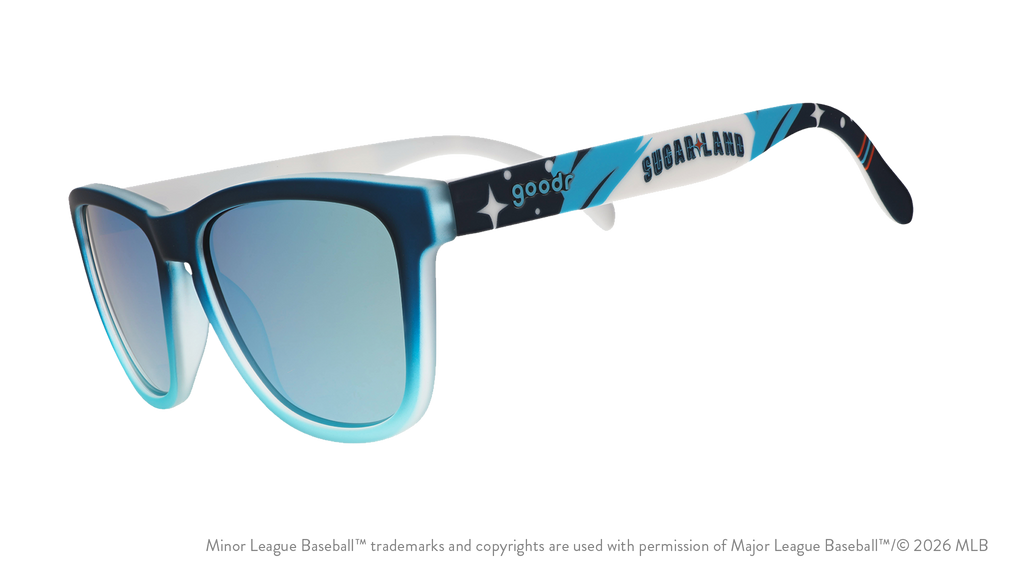 Three-quarter angle view of shades tilted down. Blue frames w/ stars, Sugar Land on temples + blue reflective lenses.