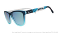 Three-quarter angle view of shades tilted down. Blue frames w/ stars, Sugar Land on temples + blue reflective lenses.