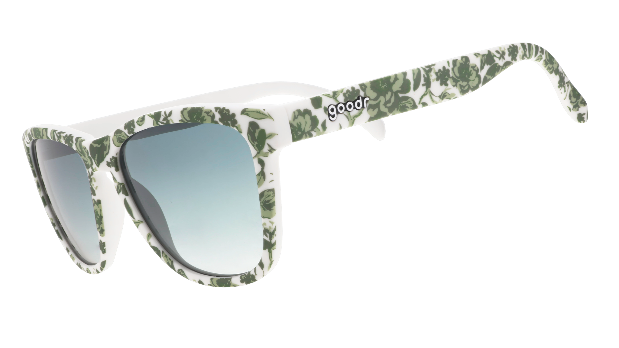 Three-quarter angle view of sunglasses with a green and white floral toile and green gradient lenses.