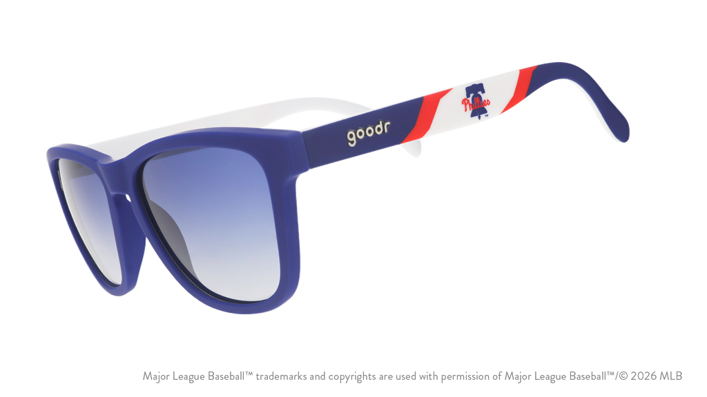Three-quarter angle view of blue, red, and white Phillies sunglasses featuring the Liberty Bell logo on the arm.