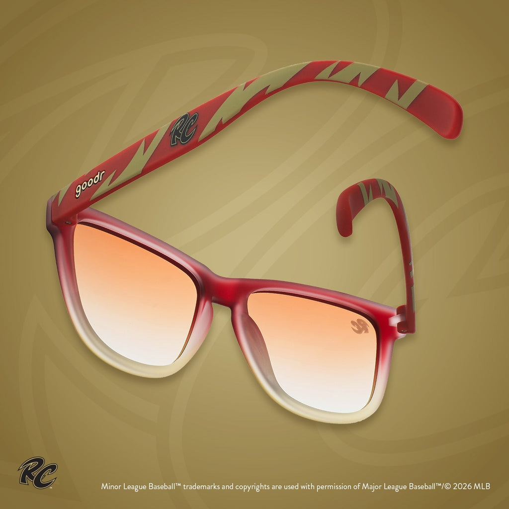 Back view of sunglasses. Brown + red frames w/ RC on temples + amber gradient lenses.