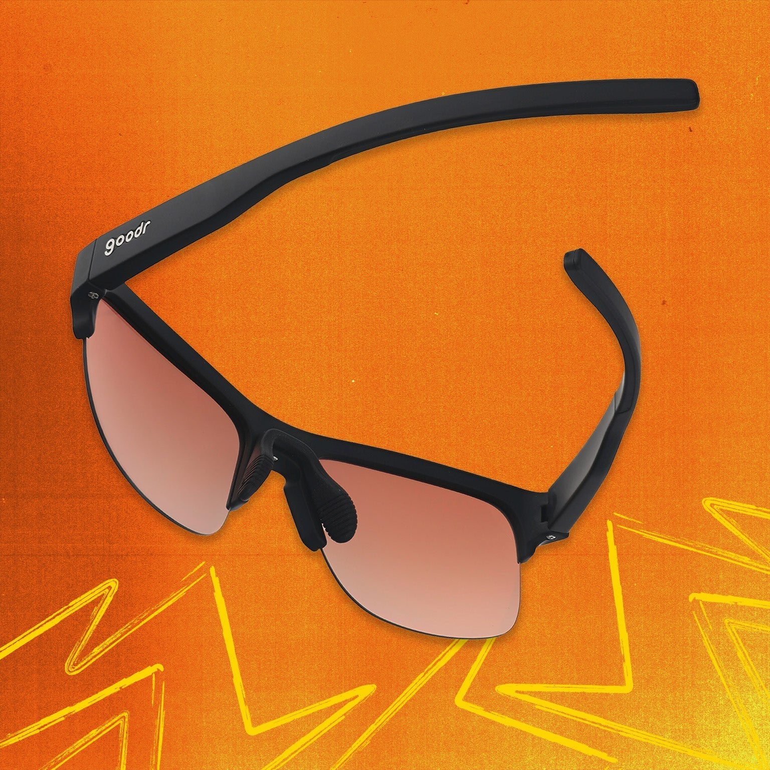 Three-quarter angle back view of black shades with orange reflective lenses tilted down on an orange background.