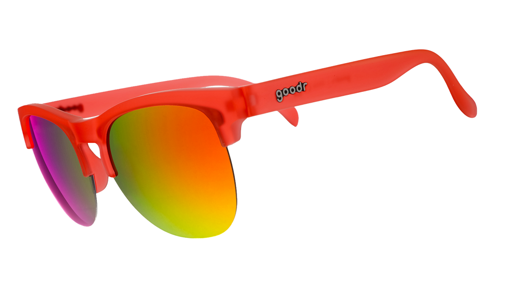 Three-quarter angle view of red-orange half-rim sunglasses with reflective red-orange lenses.