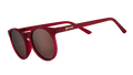 Three-quarter angle view of round burgundy sunglasses with circle-shaped non-reflective brown lenses.