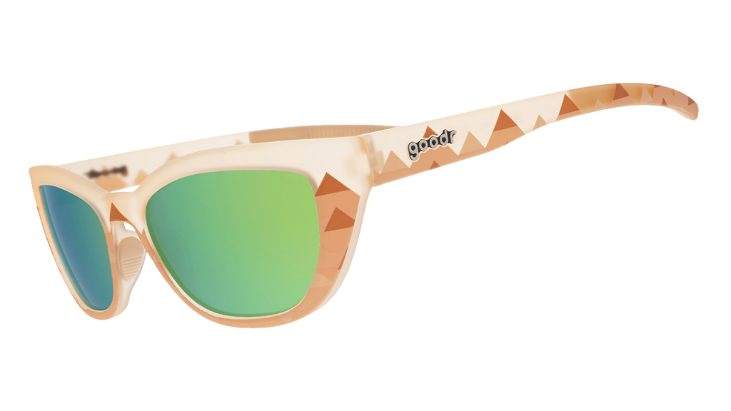 Side view of light brown sunglasses with pyramid-inspired geometric patterns and green lenses.
