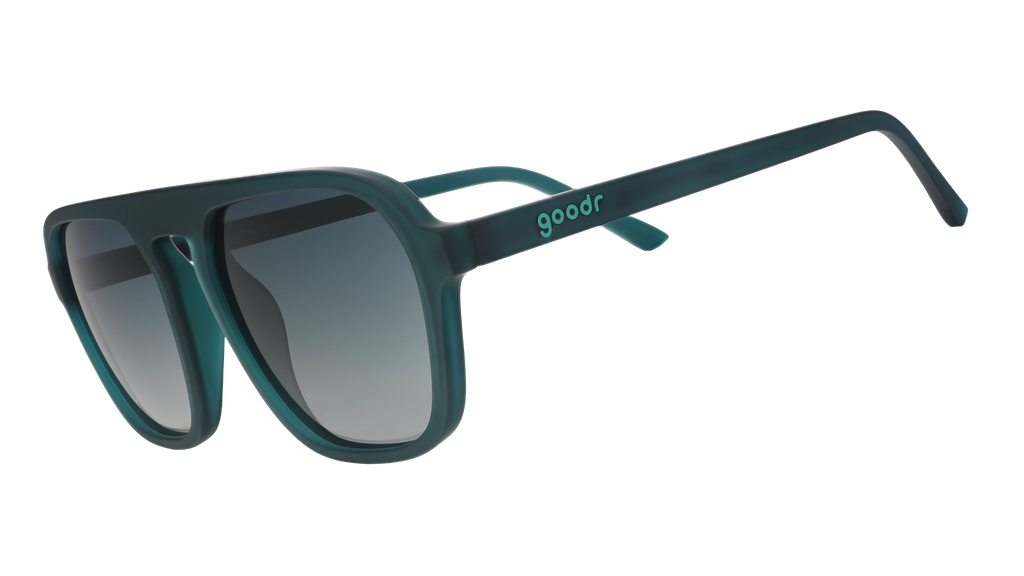 Three-quarter angle view of translucent teal Retro Gs wth green gradient lenses.