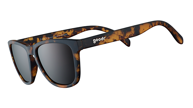 Three-quarter angle view of square brown tortoiseshell sunglasses with brown non-reflective lenses on a white background.