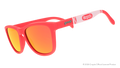 Three-quarter angle view of coral sunglasses w/ white Crayola marker pattern+burnt orange reflective lenses tilted down.