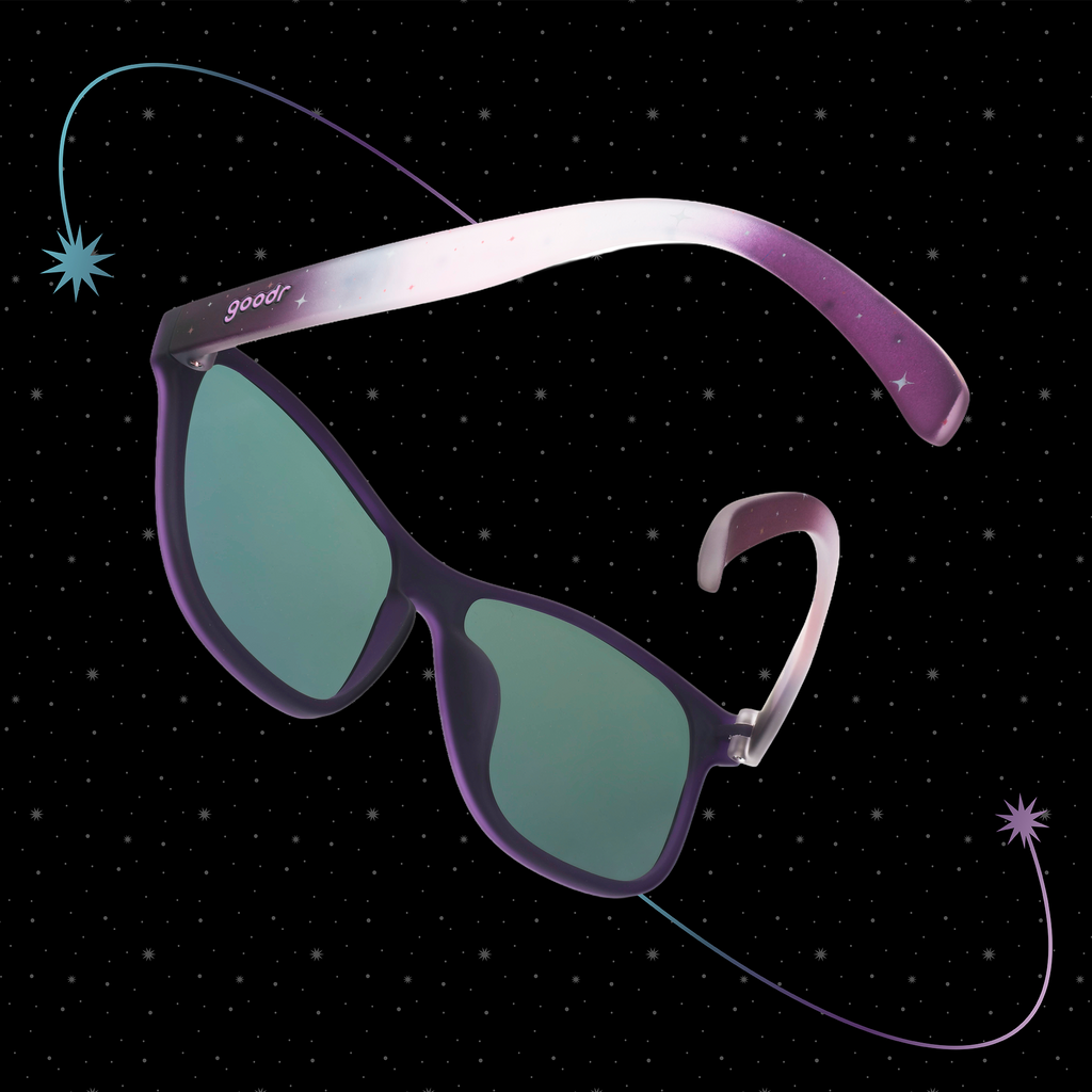 Translucent purple-blue ombre VRG frames featuring a cosmos design, photographed from behind with a starry black background.