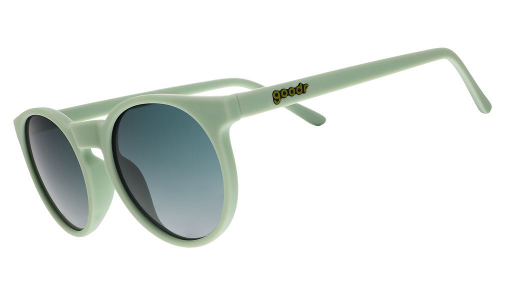 A pair of round sunglasses with mint green frames.