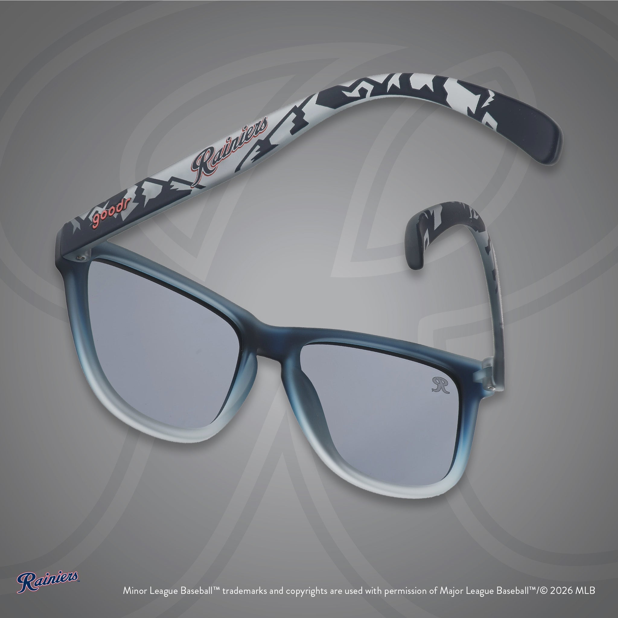 Back view of sunglasses. Gray frames w/ mountain pattern, Rainiers on temples + black non-reflective lenses.
