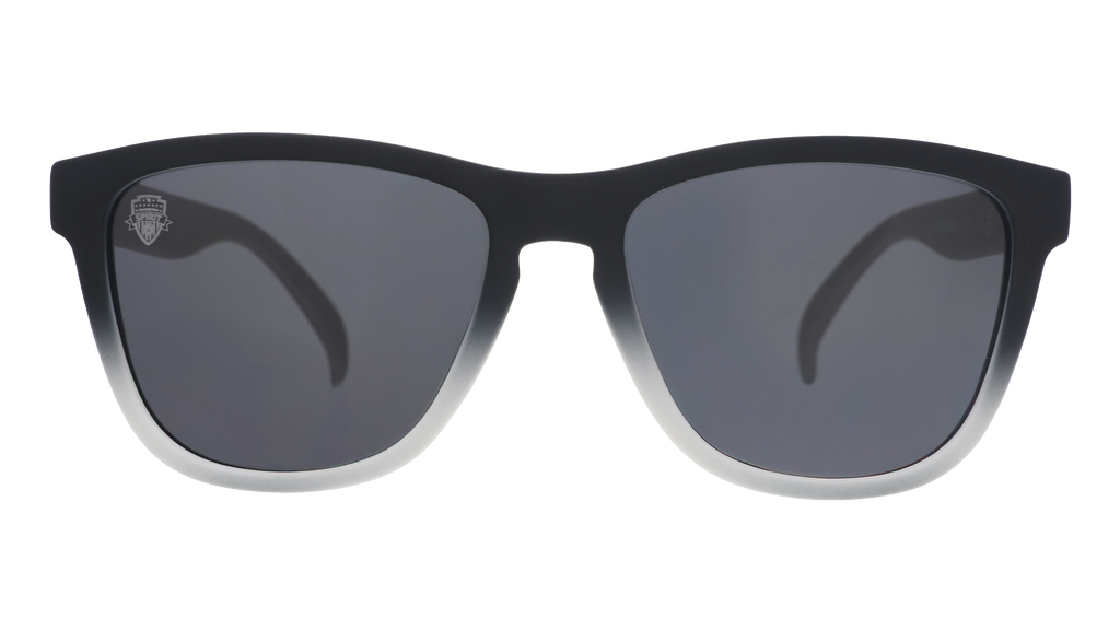 Front view of black and gray gradient sunglasses featuring black polarized lenses and the Washington Spirit crest etched into the right lens.