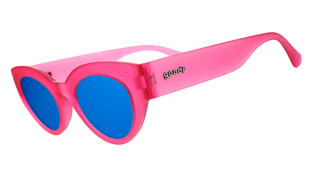 Three-quarter angle view of a pair of translucent hot pink modern cat-eye frames with dazzling blue reflective lenses.