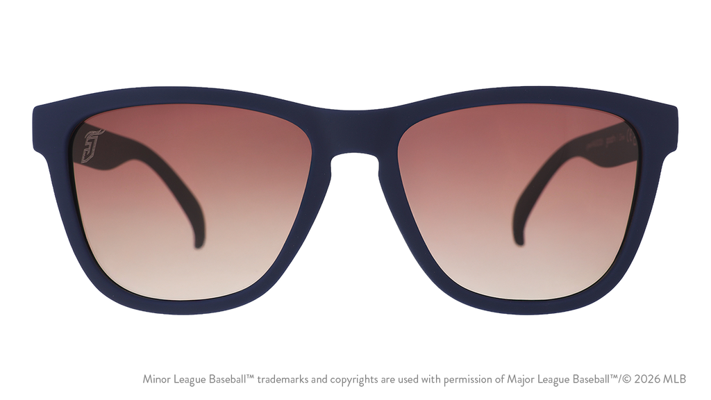 Front view of sunglasses. Blue front frame. Brown gradient lenses. Jumbo Shrimp logo etching in top corner of lens.