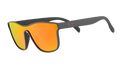 A pair of single lens goodr sunglasses with gray frames and orange/yellow reflective lenses on a white background.