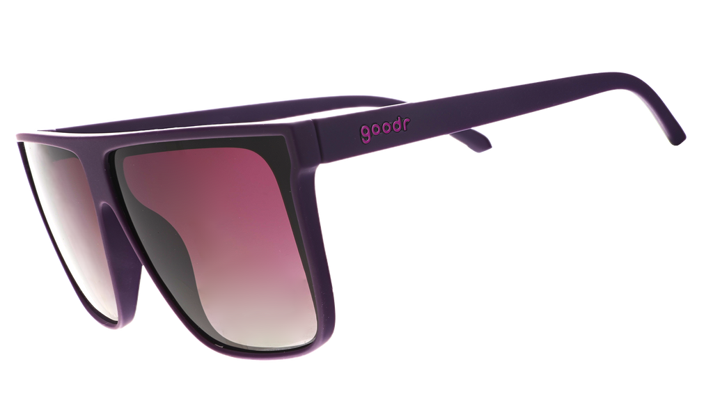 Three-quarter angle view of oversized, dark purple flat-top sunglasses with deep purple gradient lenses.