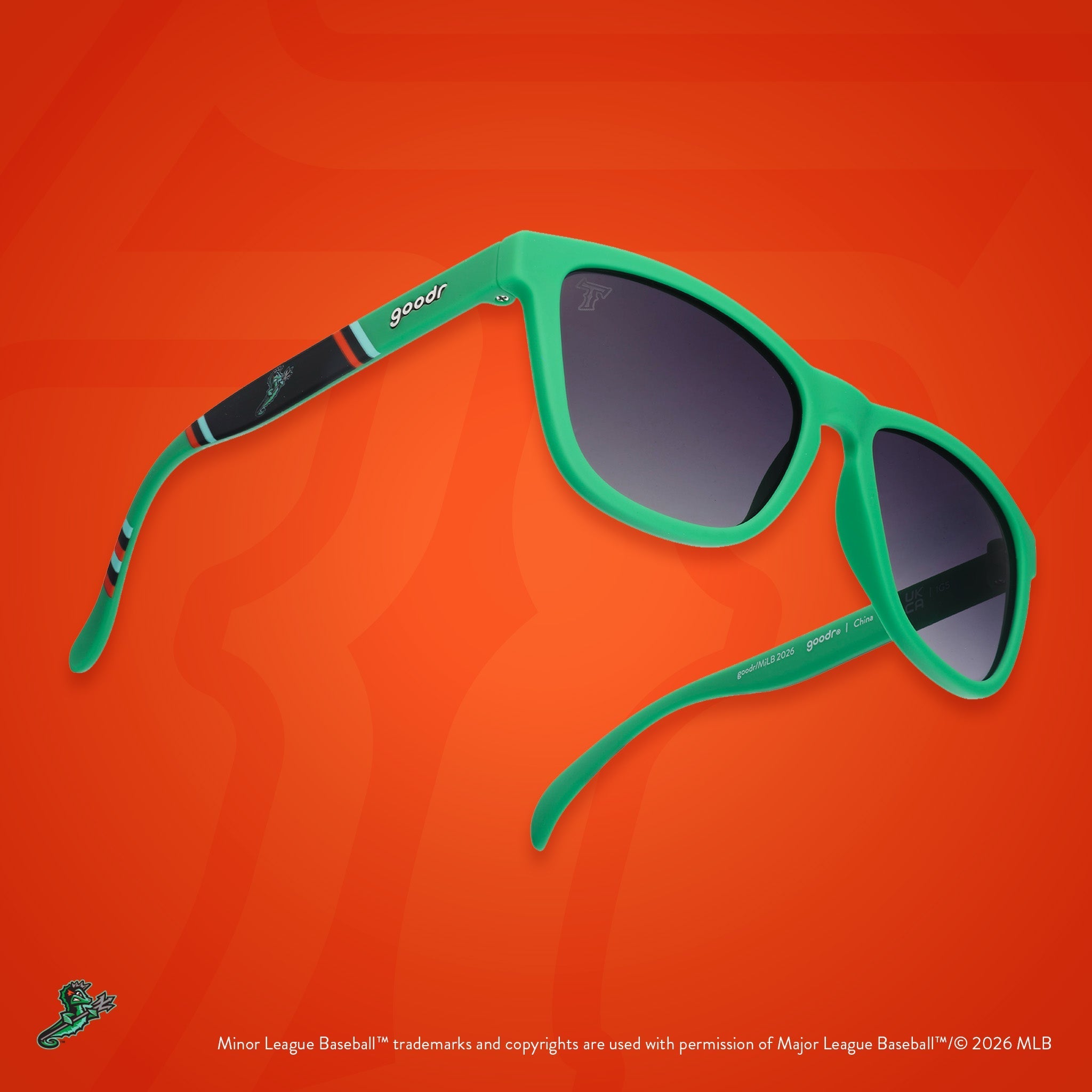 Three-quarter angle view of sunglasses. Green frames w/ a stripe pattern + Tides logo on temples. Black gradient lenses.