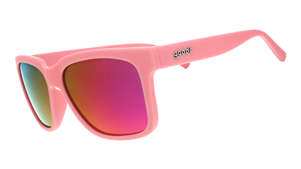 Three-quarter angle view of pink sunglasses with pink-purple lenses designed to float in water.