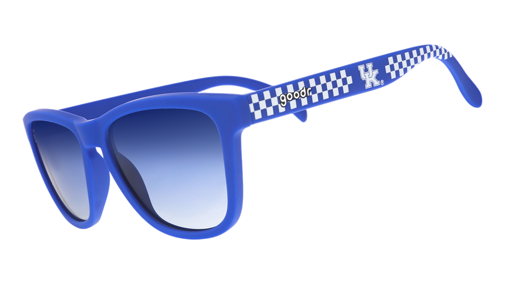 Three-quarter angle view of blue and white checkered sunglasses featuring blue gradient lenses and the University of Kentucky logo.