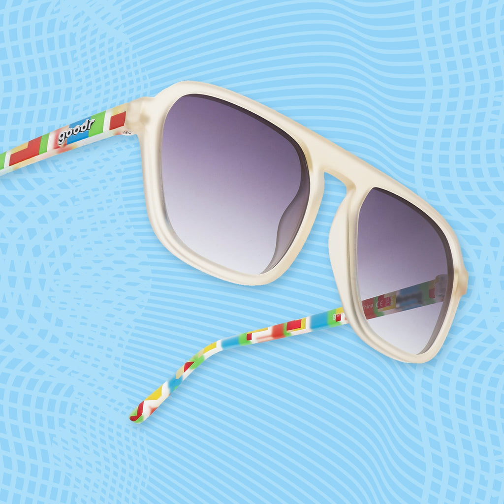 Side view of light gray sunglasses with multicolor geometric temple design and gradient lenses.
