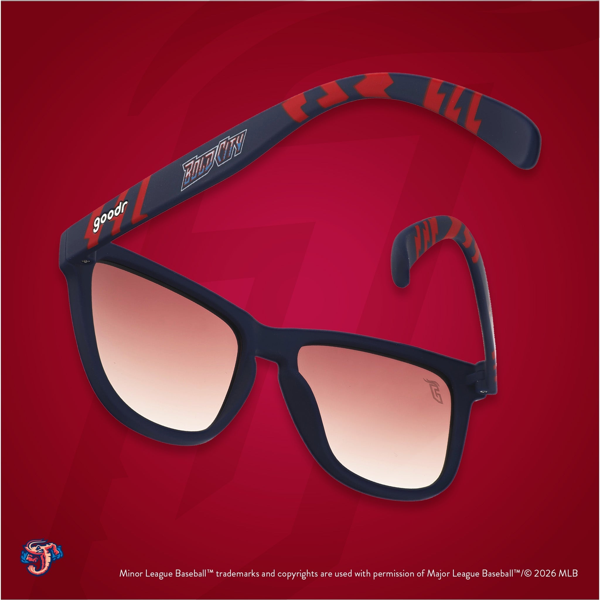 Back view of sunglasses tilted down. Blue + red frames w/ Bold City on temples. Brown gradient lenses.