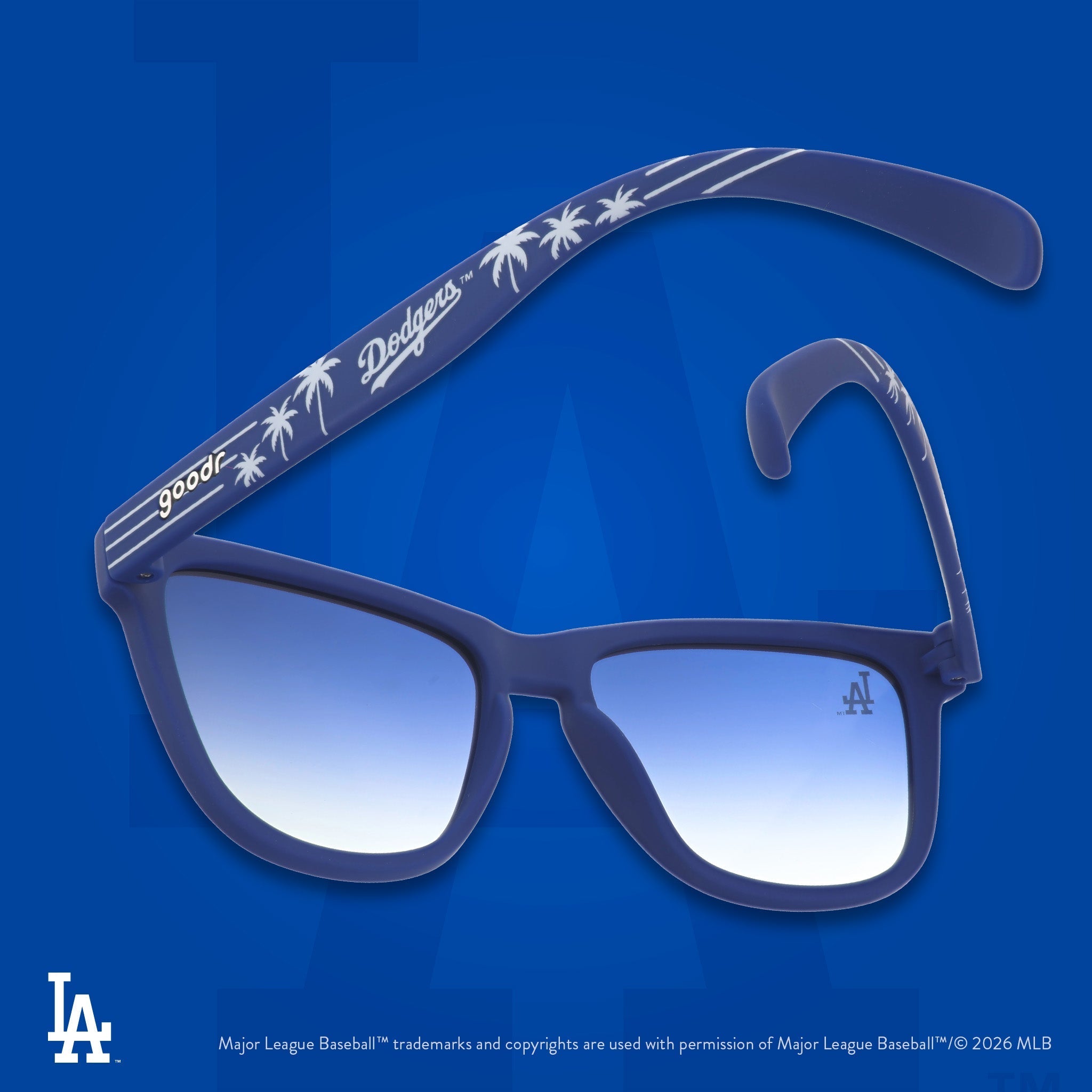 Blue and white Dodgers shades photographed from behind, floating against a blue background featuring the LA logo.