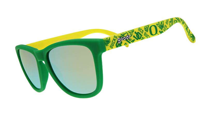 Green and yellow sunglasses with mirrored lenses, featuring a pattern of Oregon Ducks symbols and logos on the arms.