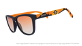 Angled view of shades tilted down. Blue frames w/ an orange+yellow landscape, Aviators logo+orange gold gradient lenses.