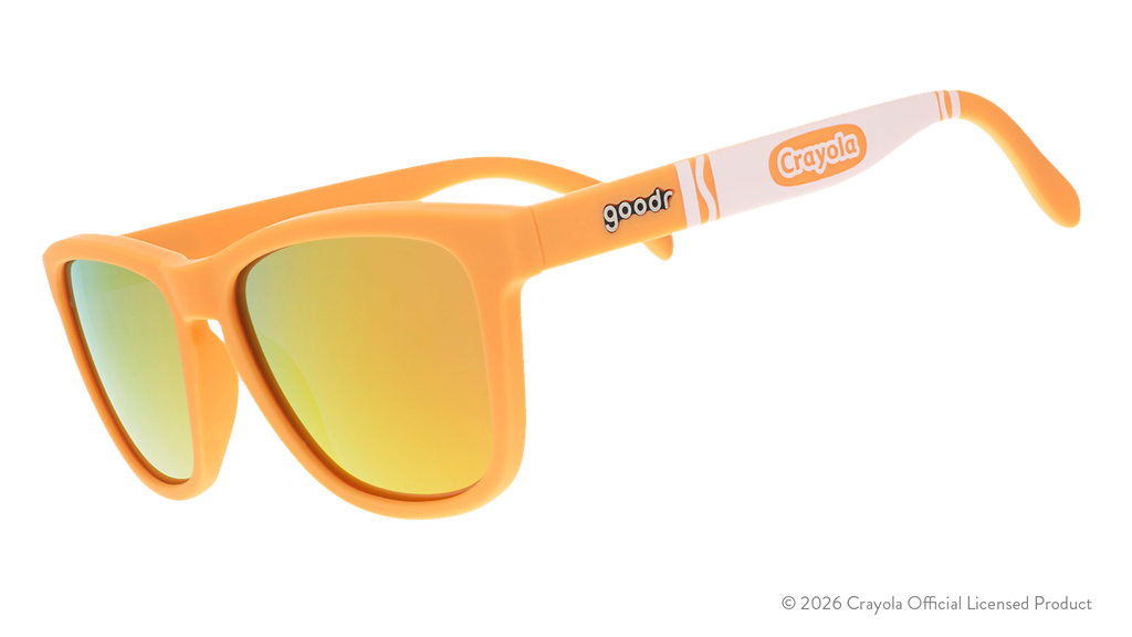Three-quarter angle view of tan sunglasses w/ white Crayola marker pattern + amber reflective lenses tilted down.