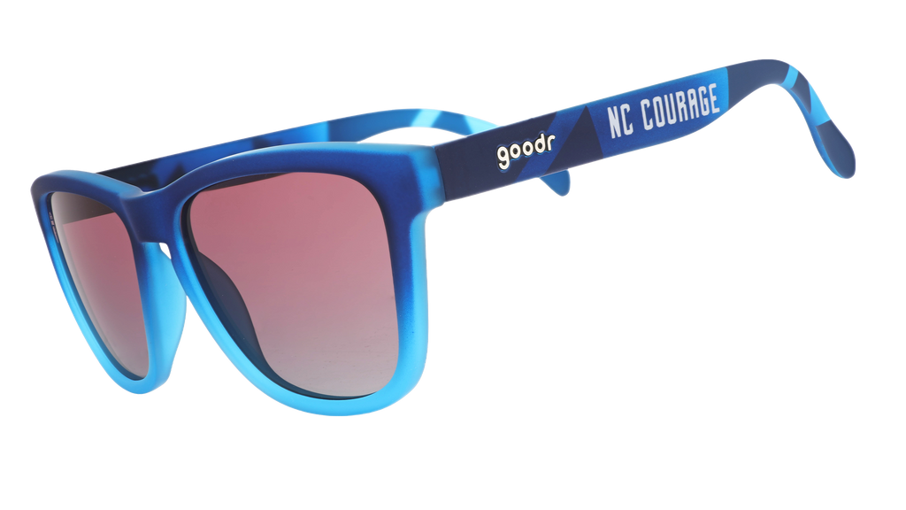 Three-quarter angle view of Atlantic blue frames with rose gradient lenses and NC Courage logo.